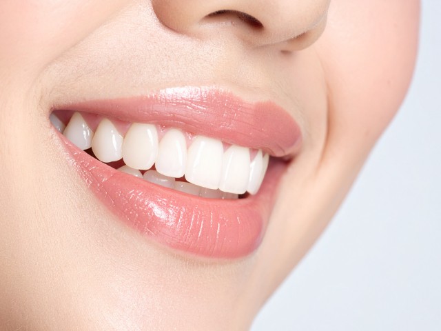 笑顔で口を開いた女性の横顔